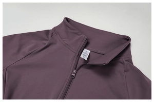 Detail of size S label and zipper on purple 78% polyamide 22% elastane yoga jacket