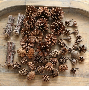 Close-up of natural pine cones and wooden sticks on a rustic tray for Christmas decor