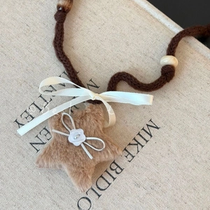 Knitted rope necklace with plush khaki star pendant and elegant white silk bow decor