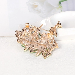 Christmas tree brooch featuring gold alloy base and secure safety pin clasp closure