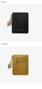 Detail view of leather mini wallets in black and yellow with gold keychains and zippers