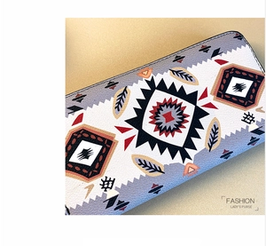 Close-up of women's leather purse featuring colorful tribal geometric patterns and texture