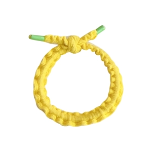 Elastic yellow braided ponytail holder for kids with green aglets on white background
