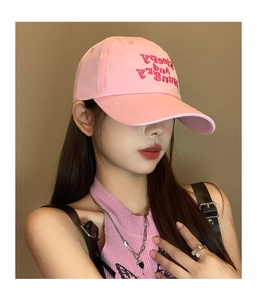 Close-up of pink cotton baseball cap featuring Sleepy And Hungry letter embroidery detail