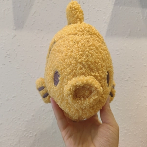 Detailed view of yellow plush fish toy with soft teddy fleece texture and embroidery