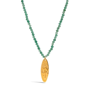 Close-up of a gold surfboard pendant with a palm tree on a green beaded necklace