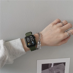 Macro view of dark green silicone digital watch with astronaut pattern and LED display