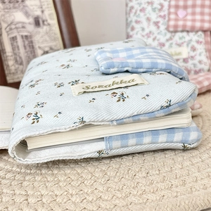 Detail of light blue floral fabric journal cover with buckle closure and cotton texture