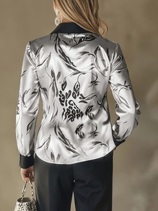 Detail of silver satin shirt back with black leaf print and premium glossy finish
