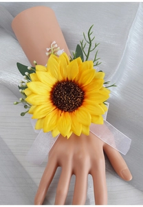 Detail of sunflower wedding wrist corsage with yellow silk petals and white ribbon