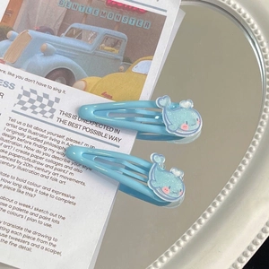 Cute blue glitter whale hair clips for girls set of two on aesthetic magazine backdrop