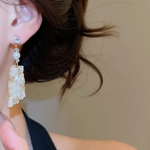 Detailed view of geometric square drop earrings with pearls and crystal accents