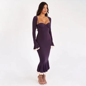 Detailed view of purple knit dress featuring ruffled mermaid hem and contrast beige edges