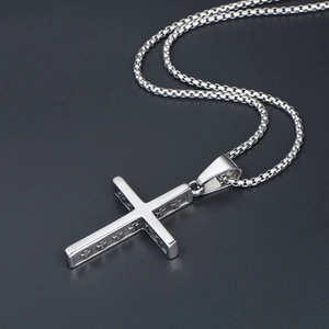 Detail of silver cross pendant with hollow edges and a durable woven stainless steel chain