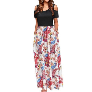 Detail of cold shoulder maxi dress featuring black bodice and paisley floral print skirt