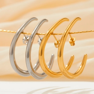 Exaggerated geometric C-shaped hoop earrings in gold and silver polished stainless steel