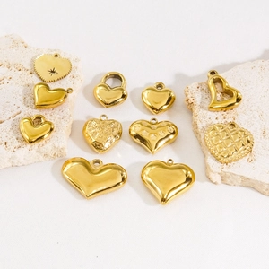 11-piece set of gold stainless steel heart charms with assorted textures and patterns