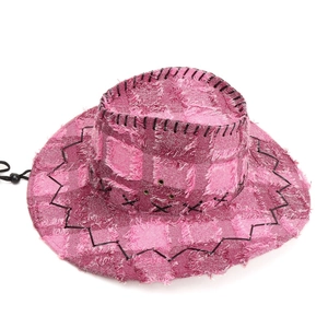 Detail of frayed edge patchwork on a rose pink western cowboy hat with black drawstring