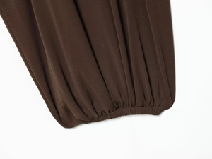 Detailed macro view of dark brown elastic lantern cuffs with fine ribbed knit texture