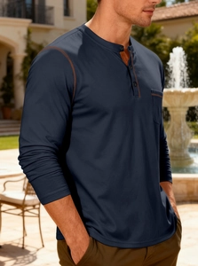 Detail of navy men's Henley shirt featuring brown contrast stitching and chest pocket