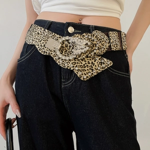 Close-up of Y2K leopard print belt with sparkling rhinestones and butterfly buckle