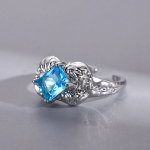 Macro shot of silver adjustable open ring featuring a square blue gemstone and relief texture
