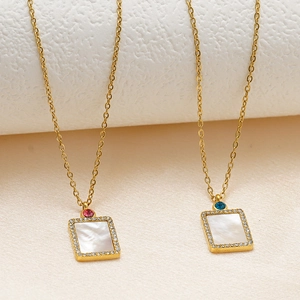 Close-up of gold shell pendant necklaces with colorful zircon and rhinestone borders