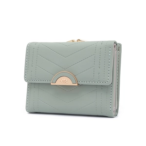 Detail of grey-green tri-fold wallet with V-quilted faux leather and golden curved clasp