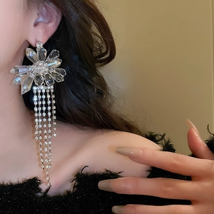 Exaggerated floral tassel earrings with luxury crystals and long silver fringe detail