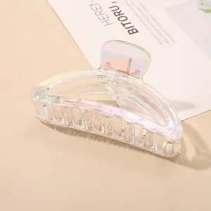 Macro detail of iridescent semi-transparent resin hair claw clip with colorful finish