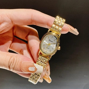 Elegant gold oval quartz watch for women with a minimalist metallic link chain strap