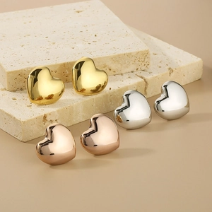 Minimalist 3D hollow heart stud earrings in polished gold, silver, and rose gold finish