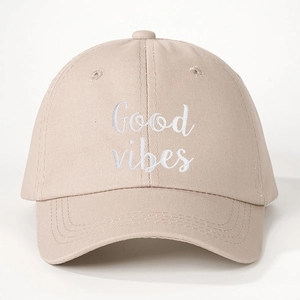Beige cotton baseball cap with white Good Vibes embroidery on a clean white background