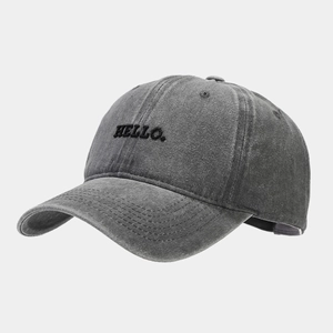 Detail of HELLO embroidery on vintage washed grey baseball cap with high cotton texture