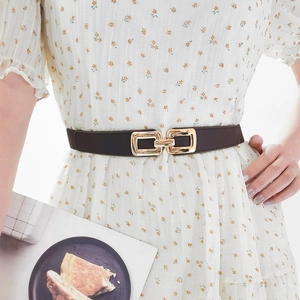 Close-up of women's elastic thin waist belt with a golden rectangular double ring buckle