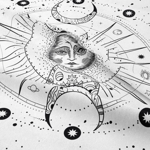 Close-up of bohemian tapestry fabric featuring celestial sun, moon, and planet patterns