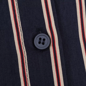Macro detail of dark blue striped fabric texture with a black four-hole button