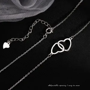 Minimalist double interlocking heart necklace in silver finish with adjustable lobster clasp