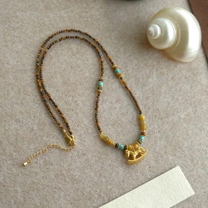 18K gold plated necklace featuring tiger eye beads and a delicate rocking horse pendant