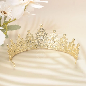 Detailed close-up of luxury gold crown with white rhinestones for wedding banquet