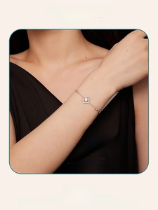Close-up of a luxury s925 silver moissanite bracelet with hollow clover petal design