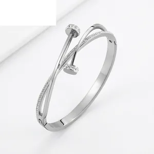 Elegant crossover nail-head titanium steel bracelet with pavé rhinestones in silver finish