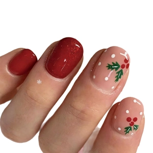 Short red Christmas press-on nails featuring glitter and holly berry hand-painted designs