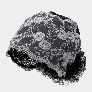 Close-up of floral lace embroidery and breathable mesh texture on the black headscarf