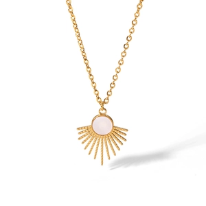Detail of vintage sunburst pendant with white natural stone on golden titanium steel chain