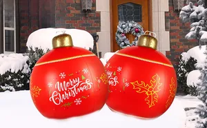 Close-up of red 60cm Christmas inflatable ball with Merry Christmas text on snow