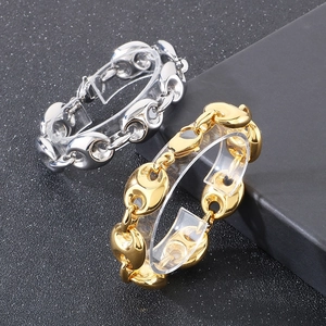 Close-up of 18k gold and silver stainless steel coffee bean link chain bracelets
