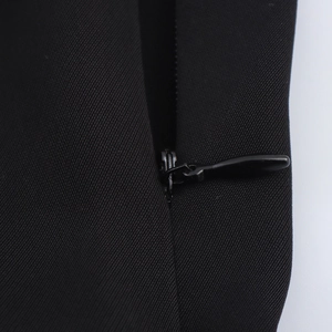 Close-up detail of a hidden back zipper on this sleeveless black commuter dress