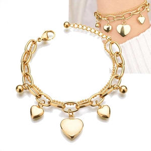 Detailed close-up of double-layer gold heart bracelet with lobster clasp and extender