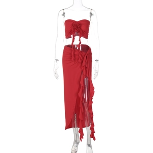 Detail of red tube top with 3D rose and ruffle skirt featuring a high side slit